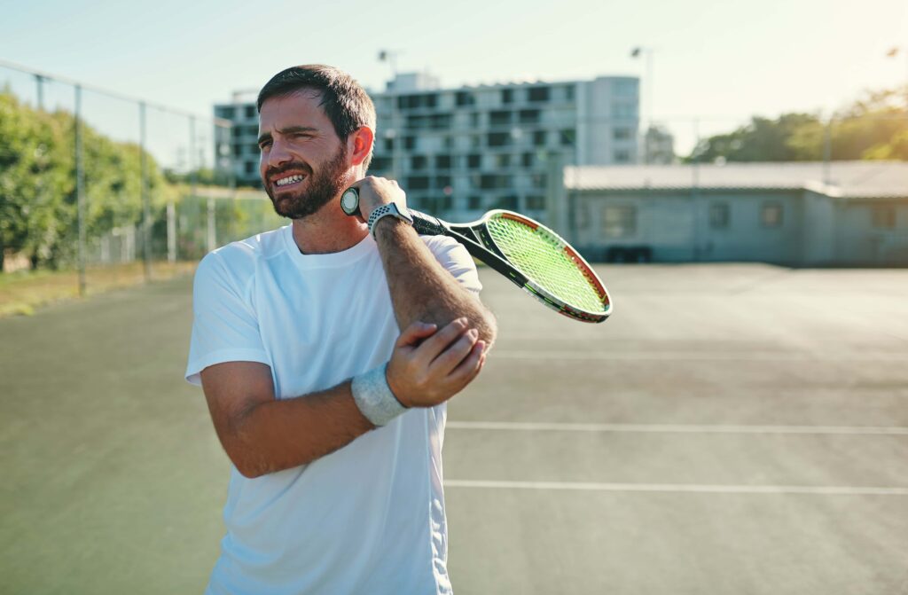 Tennis elbow is a common problem. Here is a picture of a young man playing tennis with experiencing tennis elbow.