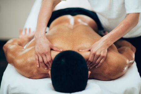 Massage has many healing benefits. A picture of a young man receiving massage therapy. Massage and chiropractic work well togther. Chiropractic Abbotsford. Back Pain