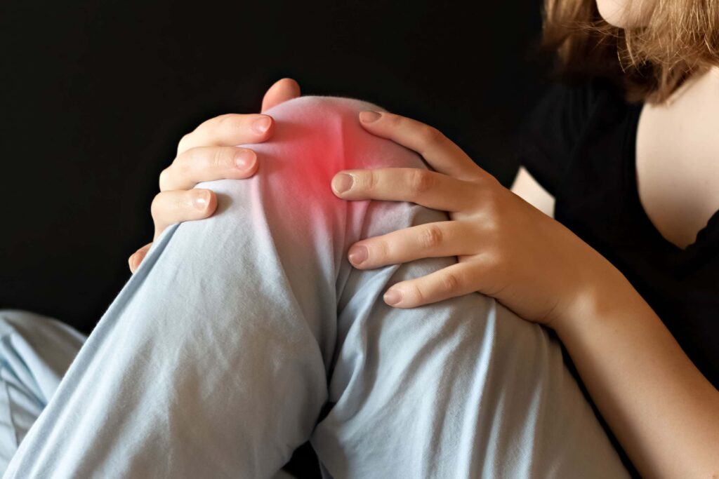 Relieve pain. Knee pain can be relieved by massage and chiropractic. Here a left knee is shown bent at ninety degrees, with red to show pain in knee joint. Knee Pain treatment. Image of red pain over a bent knee joint. Knee Pain Treatment for inflammation.