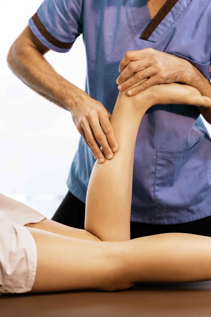 image of Chiropractic massage to increase blood flow and move lymph fluid in patient's lower leg