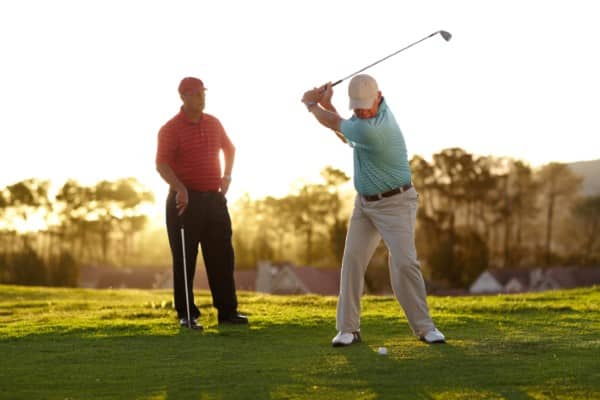 Two older male golfers going through a round of golf.