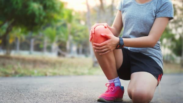 A runner woman with knee injury and pain