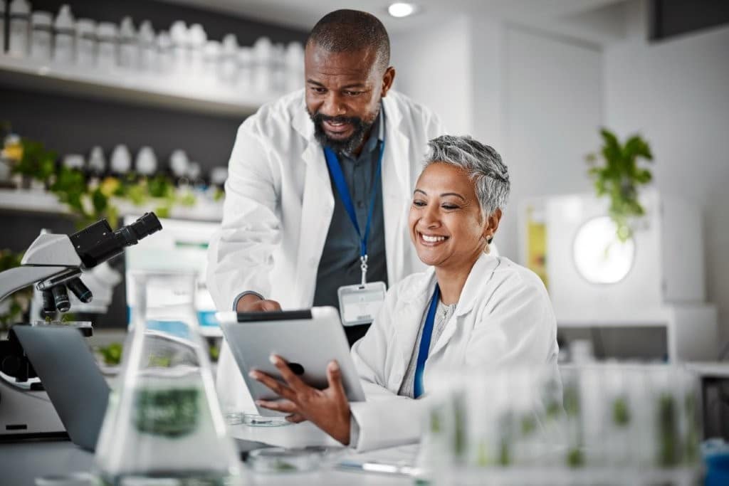 Teamwork, people or tablet in biology laboratory, science collaboration or mature medical research of engineering.