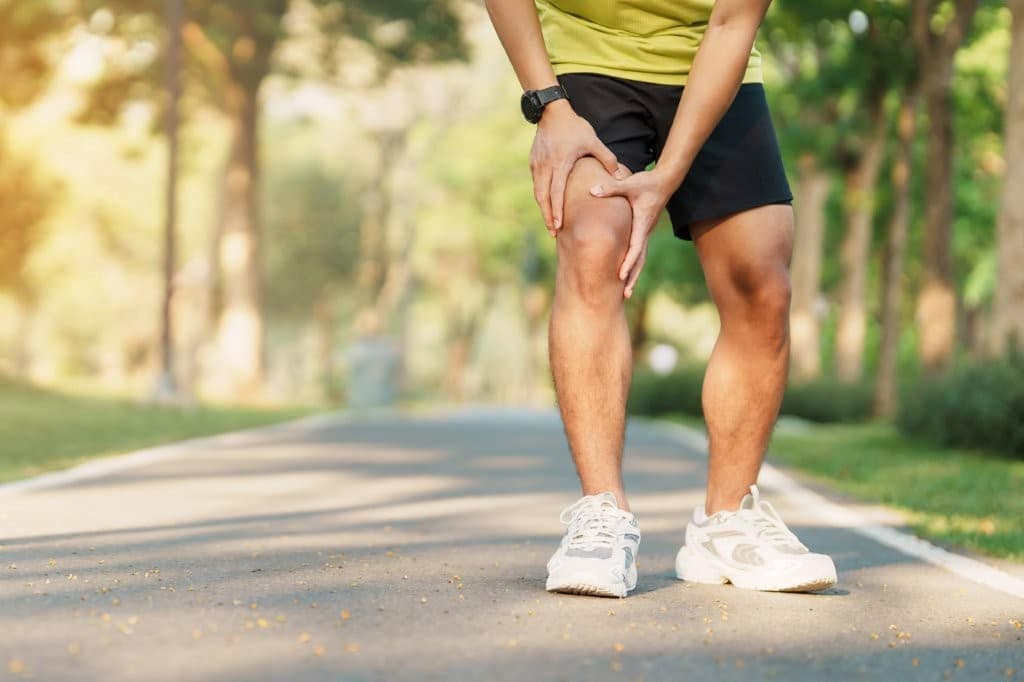 Man out for walk clutching knee in pain