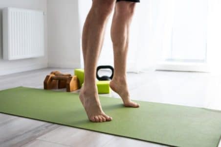Movement screen for feet, ankles, knee's and hips done by a patient standing on tip toes.