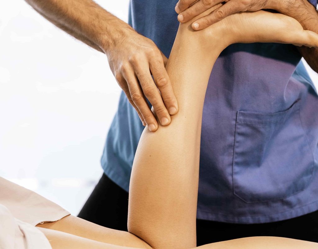 image of Chiropractic massage to increase blood flow and move lymph fluid in patient's lower leg